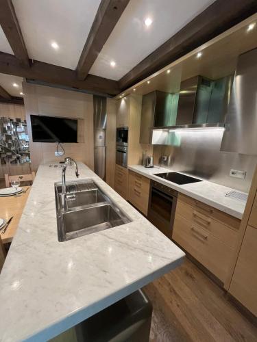a kitchen with a sink and a counter top at Le Château - Appartement Génépi in Morzine