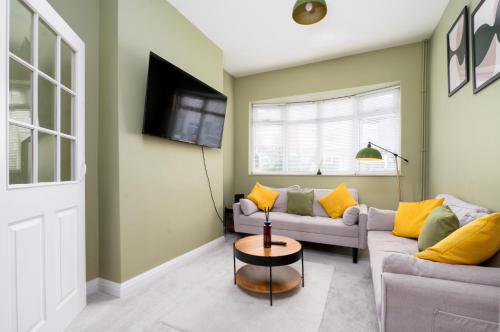 a living room with two couches and a tv at Cooper stay - perfect for contractors in Grimsby