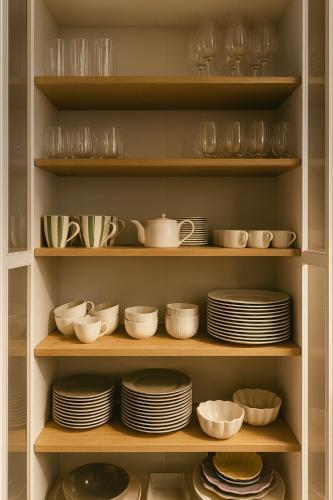 a cabinet filled with plates and bowls and dishes at Chez Gaston - Entrelacs in Pouilly