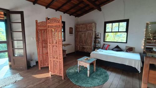 a bedroom with a bed and a ladder and a bed and a room with at Casa Encantada in Paraty