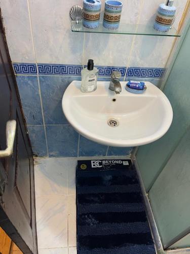 a bathroom with a sink and a drain under it at Furnished one bedroom apartment in Amman