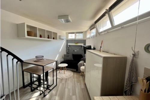 Il comprend un salon avec une petite table et une cuisine. dans l'établissement Charming T2 with Wifi near city center, à Nice