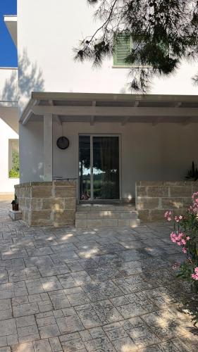 a house with a patio in front of it at MAREULIVI in Ostuni