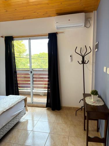 a bedroom with a bed and a large window at HFB Aparts in Eldorado