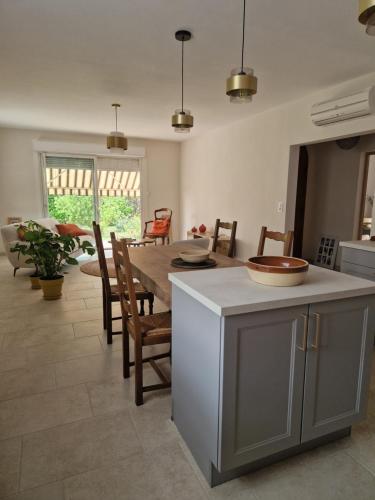 a kitchen and dining room with a table and chairs at Les LUCIOLES in Nyons