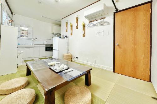 a kitchen with a wooden table and two chairs at Momo House Near Komagome easy to shinjuku, Ueno, Tokyo in Tokyo