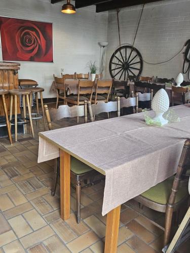 a dining room with a table and some chairs at Partyraum Waldeslust Preis nach Anfrage in Oelde