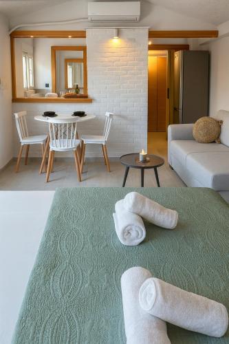 a living room with towels on a green rug at Marcia's Welcome House in Rafina