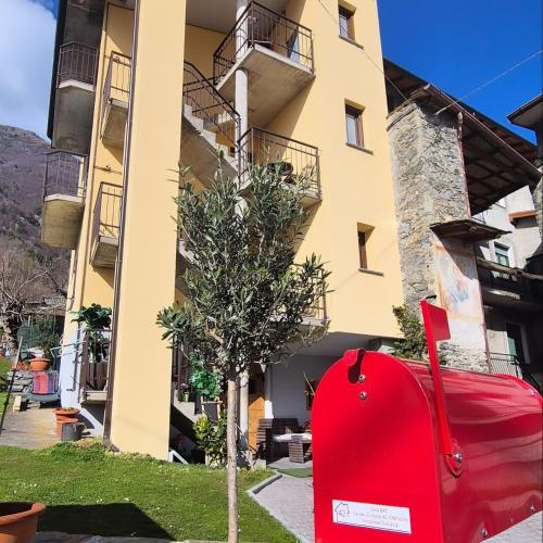 a red car parked in front of a building at CASA BAT in Mantello