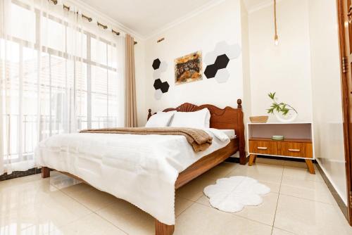 a bedroom with a bed and a large window at kigali Pillar House inn in Kigali
