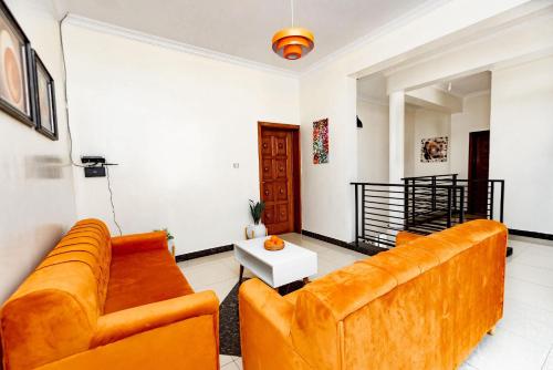 a living room with a couch and a table at kigali Pillar House inn in Kigali