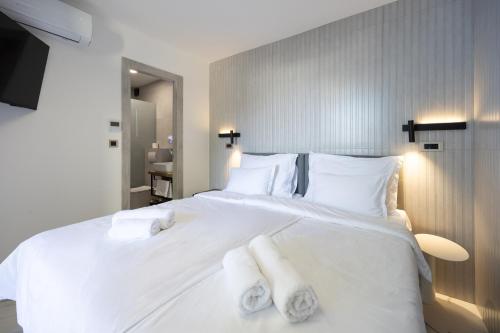 a bedroom with a large white bed with towels on it at Hotel - Teranea City Hvar in Hvar