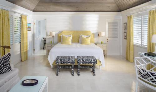 a white bedroom with a bed and a couch at Round Hill Hotel & Villas in Montego Bay