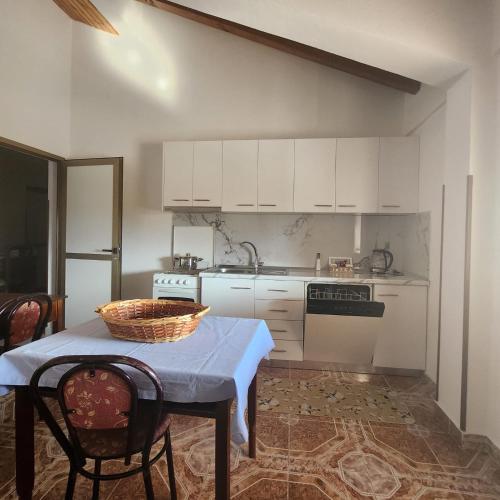 a kitchen with a table with a basket on it at REZIDENCA ARBNORE - Tre Horizonte in Koplik