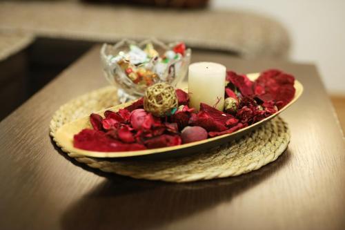 a plate of food with a candle on a table at ILIEVSKI apartment 8 in Kumanovo