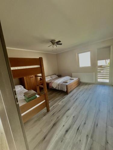 a room with two bunk beds and a ceiling fan at Apartment in Frydman, Poland in Frydman