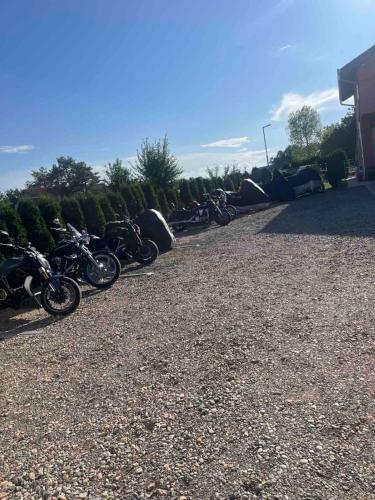 a row of motorcycles parked in a parking lot at Vila Boska Palic in Palić
