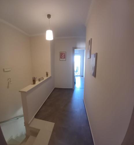 an empty room with a hallway with a stair case at Mitikas Resort in Mytikas