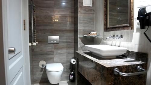 a bathroom with a sink and a toilet at Galata Fil Hotel in Istanbul
