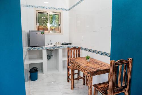 a dining room with a table and a sink at Casa May May in Cobá
