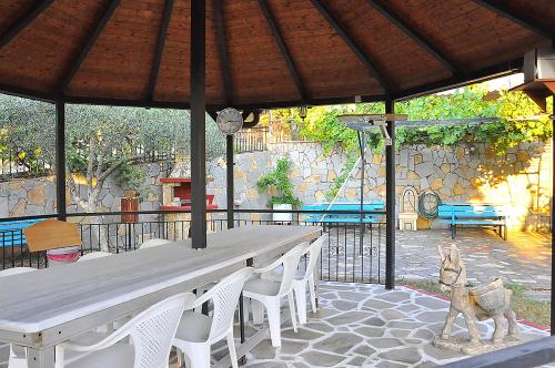 a table and chairs under an umbrella on a patio at Studios Kostas & Despina in Lidia