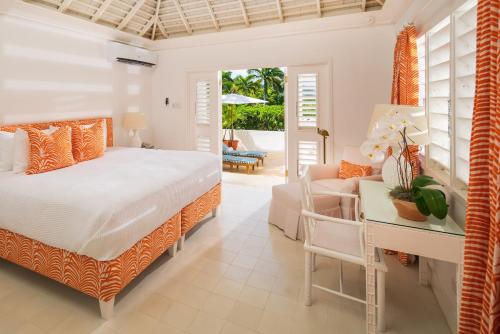 a bedroom with a bed and a desk and a couch at Round Hill Hotel & Villas in Montego Bay