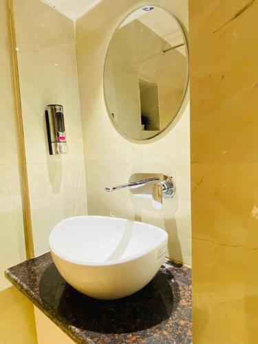 a bathroom with a bowl sink and a mirror at The Commune Banaras in Varanasi