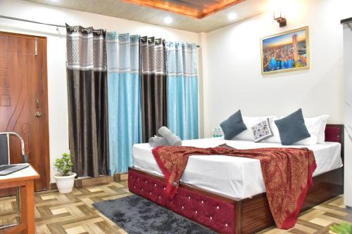 a bedroom with a large bed in a room at A Greenwoods Hotel in Solan