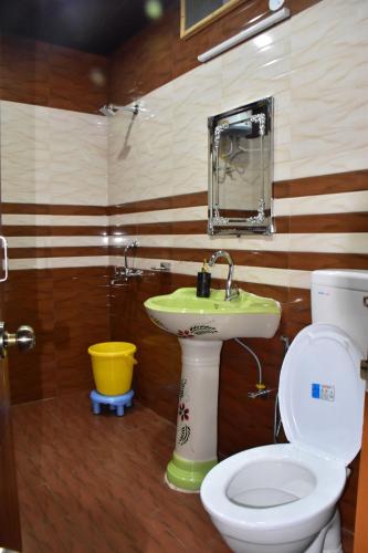 a bathroom with a toilet and a sink at The Blissful Escapes !!! in Dharampur
