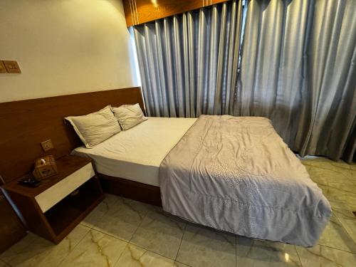 a hotel room with a bed and a window at Hotel Seven View in Bāiljuri