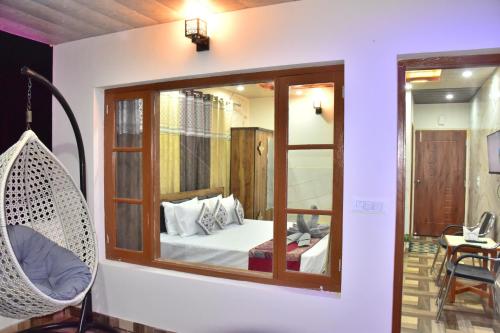 a room with a mirror and a bed and a chair at The Blissful Escapes !!! in Dharampur