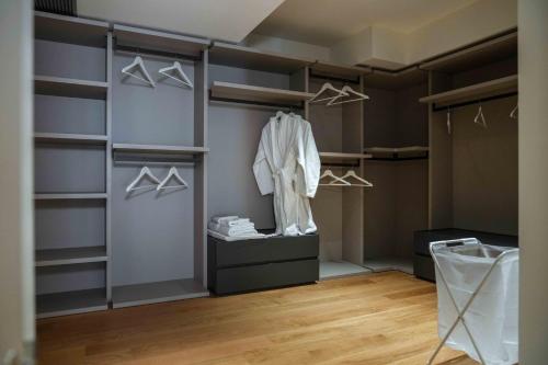 a walk in closet with shelves and hangers at Angela Suite - Luxury loft near Politecnico and city center in Turin