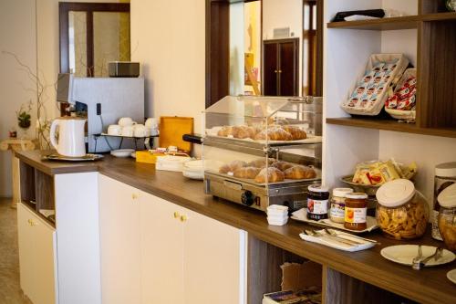 a kitchen with a counter with some pastries on it at Hotel Vallisdea in Sala Consilina