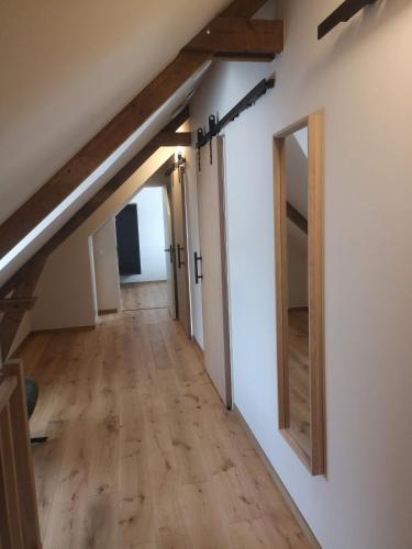 a hallway in a loft with wooden beams at Huyze Basco in Poperinge