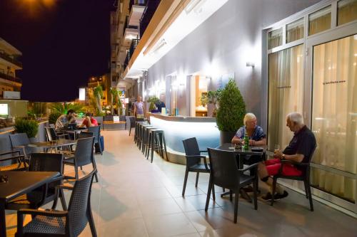 people sitting at tables in a restaurant at Astali Hotel in Rethymno