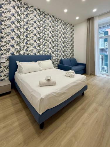 a bedroom with a blue bed and a blue couch at Elysium Relais in Naples