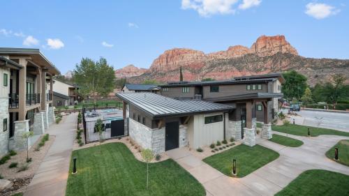 an aerial view of a house with mountains in the background at Montclair at Zion in Springdale