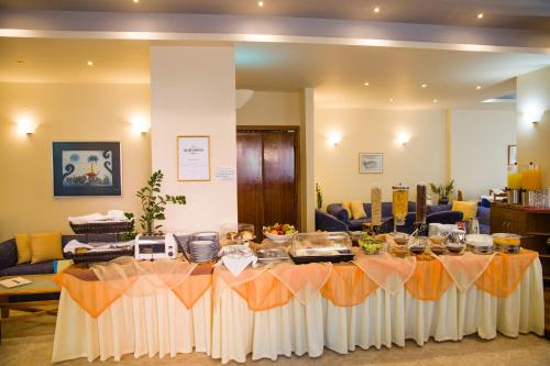 ein langer Tisch im Wohnzimmer mit Buffet in der Unterkunft Astali Hotel in Rethymno