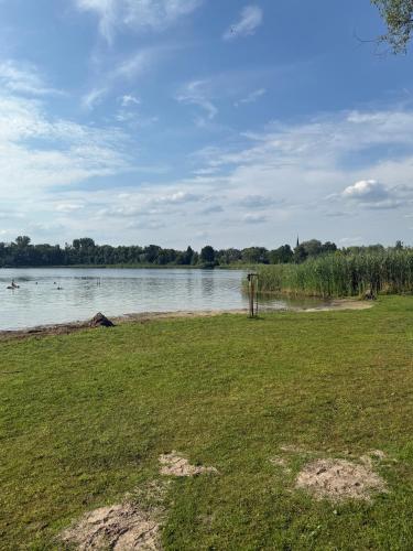 a grassy field next to a body of water at Ferienwohnung Last in Kyritz