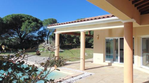 a house with columns and a patio at La Pampa au Mas des Issarts in Saint-Jean-de-Fos