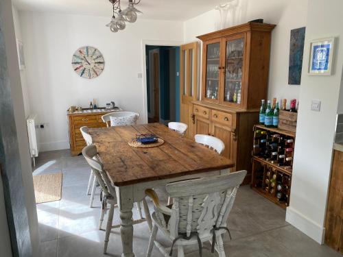 a dining room with a wooden table and chairs at New listing in Uplyme Cranbrook situated on the river Lym footpath in Uplyme