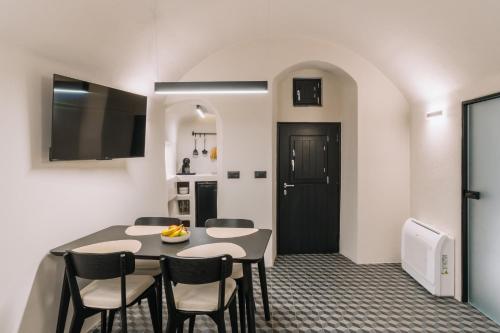 a kitchen and dining room with a table and chairs at Noir Cave Villa with private Jacuzzi and Sunset Terrace in Pirgos