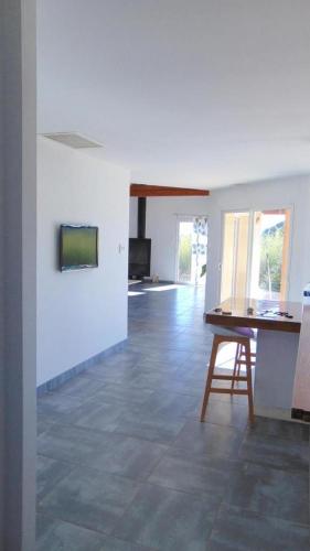 a living room with a table and a chair at La Pampa au Mas des Issarts in Saint-Jean-de-Fos