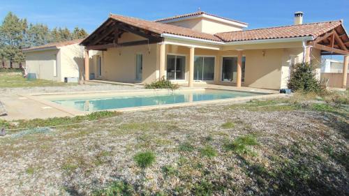 a house with a swimming pool in front of it at La Pampa au Mas des Issarts in Saint-Jean-de-Fos