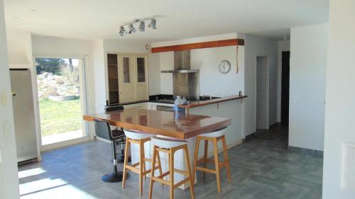 a kitchen with a wooden counter and a kitchen island at La Pampa au Mas des Issarts in Saint-Jean-de-Fos