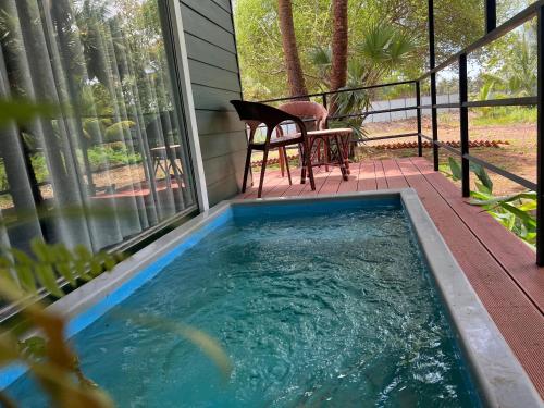 a hot tub on the porch of a house at Leopard Inn Wilpattu in Ilavankulam