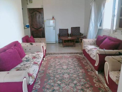 a living room with couches and a rug at مرسي مطروح in Marsa Matruh