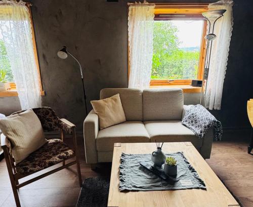 a living room with a couch and a coffee table at Linken Studio for 2 in Narvik
