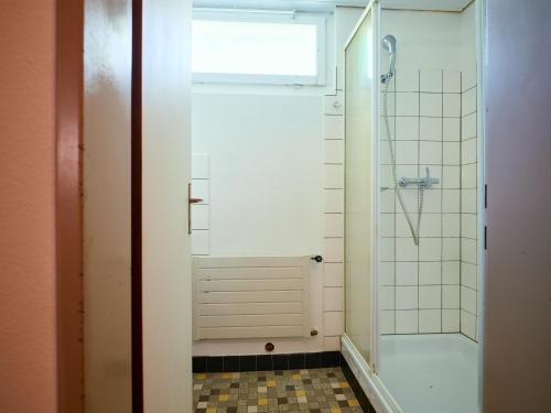 a bathroom with a shower with a glass door at Löwen Lodge in Seelisberg
