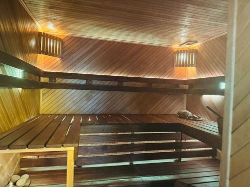 a sauna with a bench in the middle at Family apartment with pool & garden view in Mārupe